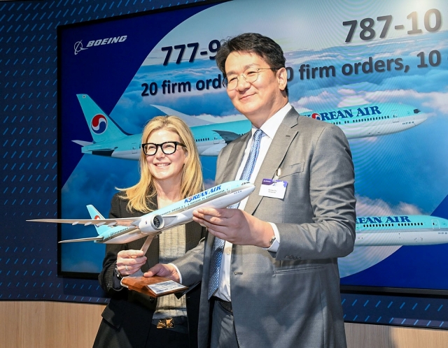 Korean Air Chairman and CEO Walter Cho (right), and Stephanie Pope, president and CEO of Boeing Commercial Airplanes, pose during a memorandum of understanding signing ceremony at the Farnborough International Airshow 2024 held in the UK on July 22. (Korean Air)