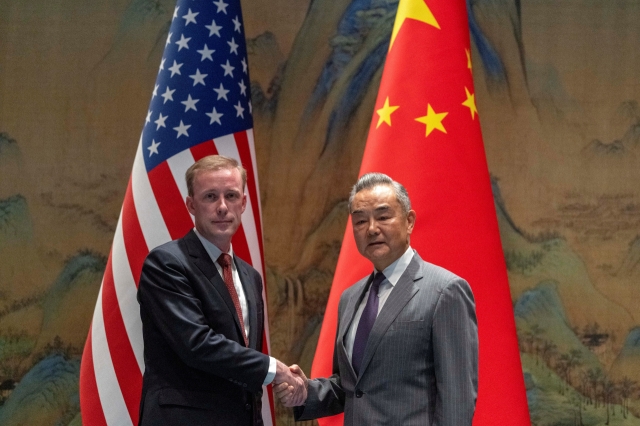 Wang Yi, the director of the Communist Party's Central Foreign Affairs Commission Office shakes hands with White House National Security Adviser Jake Sullivan at Yanqi Lake in Beijing, China, Tuesday. (Pool Photo via Reuters)