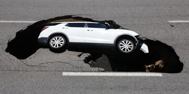 A sinkhole has swallowed up a car on a road in Seoul's Seodaemun-gu, on Thursday. (Yonhap)