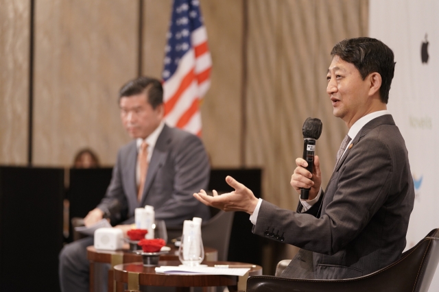 Minister of Trade, Industry and Energy Ahn Duk-geun (right) speaks at a conference hosted by the American Chamber of Commerce in Korea, Thursday. (AmCham)