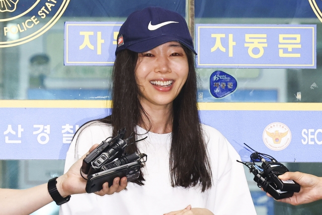 Then-Ador CEO Min Hee-jin speaks to reporters while leaving Yongsan Police Station in Seoul on July 9, following questioning over her alleged breach of trust. (Newsis)