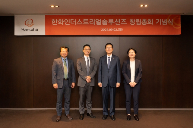 Hanwha Industrial Solutions CEO Ahn Soon-Hong (second from right) and other company officials pose for a photo during the company's inaugural general meeting at The Plaza Hotel in Seoul on Monday. (Hanwha Group)