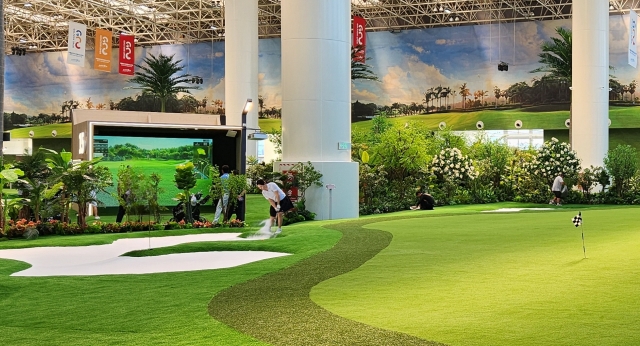 A player makes a bunker shot at an indoor green at City Golf's Tianjin branch in China.