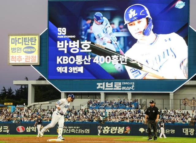 Park Byung-ho of the Samsung Lions rounds third base after hitting his 400th career home run in the Korea Baseball Organization during a regular-season game against the Doosan Bears at Samsung Lions Park in the southeastern city of Daegu on Sept. 4, 2024, in this photo provided by the Lions. The scoreboard shows Park's accomplishment as the third player in league history to reach the 400-homer plateau. (PHOTO NOT FOR SALE) (Yonhap)