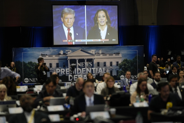 A presidential debate between Republican presidential nominee former President Donald Trump, on screen at left, and Democratic presidential nominee Vice President Kamala Harris, right, is seen from the spin room on Tuesday in Philadelphia. (AP)