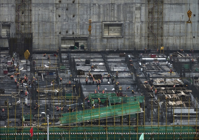 Construction workers work at a large building site in the Central Business District on April 13, 2023 in Beijing, China. (Getty Images)