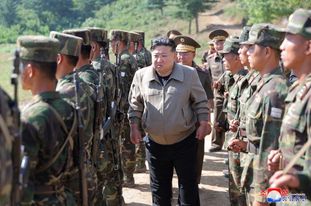 North Korean leader Kim Jong-un (center) inspects an unnamed military base on Sept. 11. (KCNA-Yonhap)