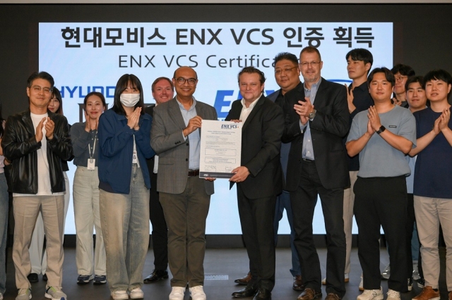 Hyundai Mobis officials hold the cybersecurity certification given by ENX Association at the company's technology research center in Yongin, Gyeonggi Province, Thursday. (Hyundai Mobis)