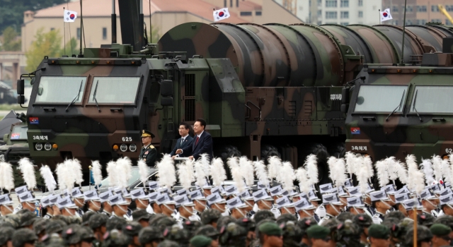 President Yoon Suk Yeol (center) passes by a transporter erector launcher carrying the Hyunmoo-5 ballistic missile during a ceremony marking Armed Forces Day on Tuesday at Seoul Air Base in Seongnam. (Yonhap)