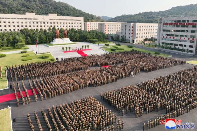 North Korean leader Kim Jong-un (center on the podium) delivers a speech during a visit to Kim Jong-un University of National Defense in Pyongyang on Monday, marking the school's 60th anniversary, in this photo provided by the North's official Korean Central News Agency the following day.