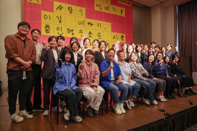 Same-sex couples pose for a photo as they announce their attempt to register their marriages in the country in Seoul on Thursday. (Yonhap)