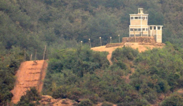 A newly installed guard post and barbed wire fence in Gaepung County, North Hwanghae Province, North Korea, is seen from the Ganghwa Peace Observatory in Ganghwa County, Incheon, on Oct. 4.