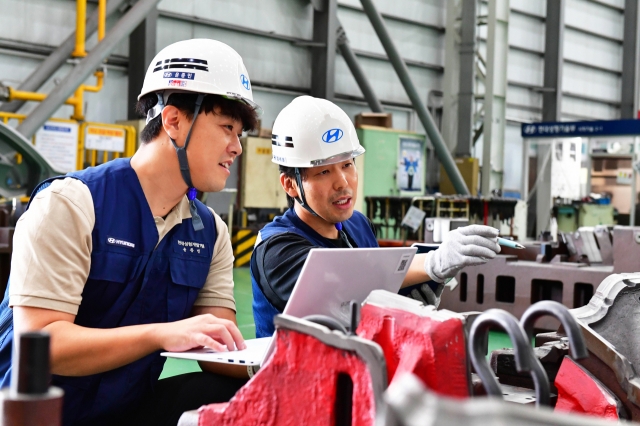 Hyundai Motor officials check the status of automotive body parts produced through the automaker's automatic press die design system. (Hyundai Motor Group