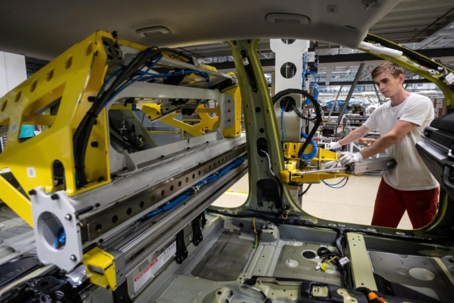 A Kia employee works on a car assembly line at the company’s auto manufacturing plant in Zilina, northwestern Slovakia. (Kia)