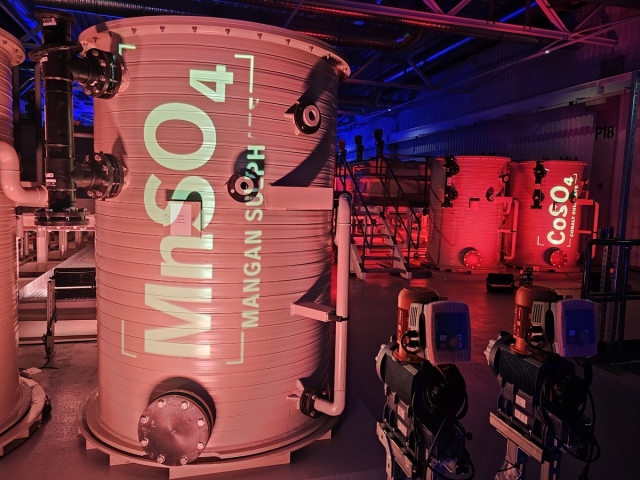 These brightly lit tanks marked with “MnSO4” and “CoSO4” are key to breaking down old electric vehicle batteries and recovering valuable metals like manganese and cobalt. (Mercedes-Benz)