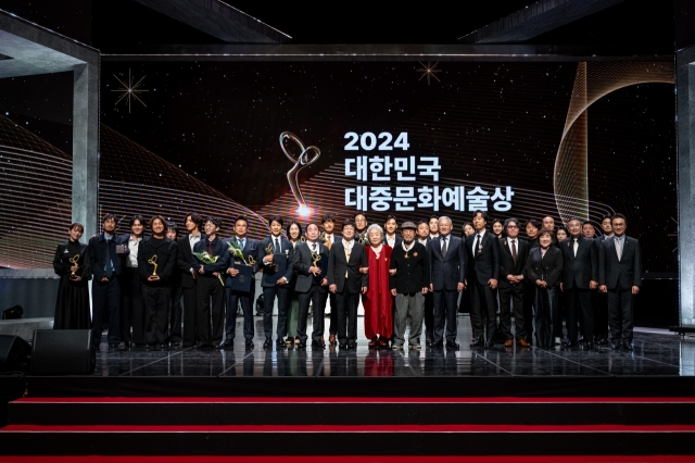 Recipients of the 2024 Korea Popular Culture and Arts Awards pose for photos at the awards ceremony held at the National Theater of Korea in Seoul on Thursday. (Korea Creative Content Agency)