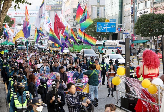 Holding rainbow flags, participants march during the Incheon Queer Culture Festival on Nov. 2, 2024, in the city of Incheon, west of Seoul. (Yonhap)