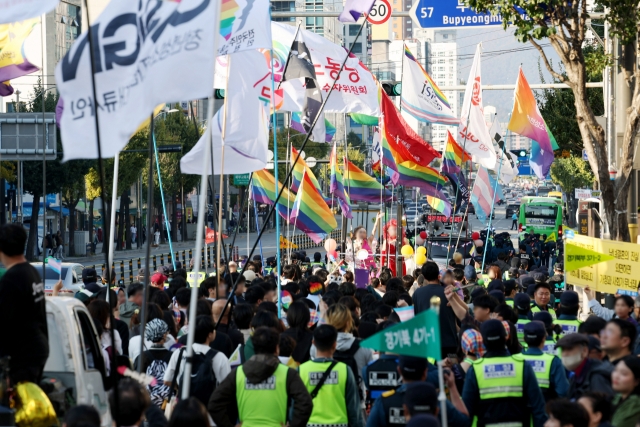 Holding rainbow flags, participants march during the Incheon Queer Culture Festival on Nov. 2, 2024, in the city of Incheon, west of Seoul. (Yonhap)