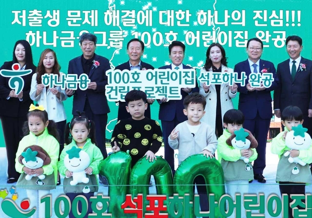 Hana Financial Group CEO Ham Young-joo (fifth from left, second row), community officials, parents and their children pose for a photo to celebrate the group's 100th child care center in Bonghwa-gun, North Gyeongsang Province, on Thursday. (Hana Financial Group)