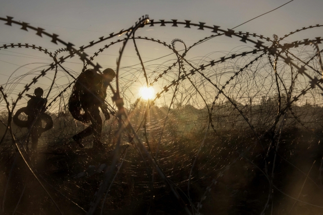 This handout photograph shows engineers of the 24th mechanized brigade named after King Danylo installing razor wire along the frontline in the Donetsk region, amid the Russian invasion in Ukraine. (Press service of the 24th mechanized brigade named after King Danylo/AFP/Yonhap)