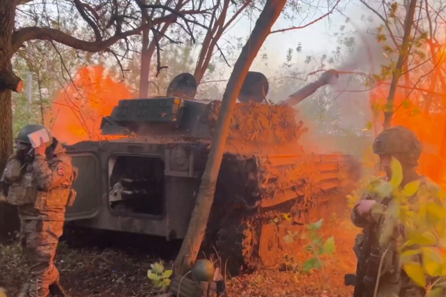 In this photo taken from a video released by Russian Defense Ministry press service on Wednesday, Oct. 30, Russian Gvozdika 120mm howitzer fires towards Ukrainian positions at border area of Kursk region, Russia. (AP)