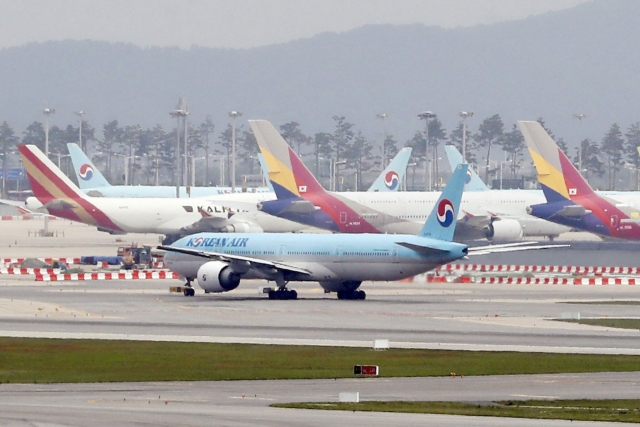 Planes of Korean Air Co. and Asiana Airlines Inc. are seen on the tarmac at Incheon International Airport, west of Seoul. (Newsis)