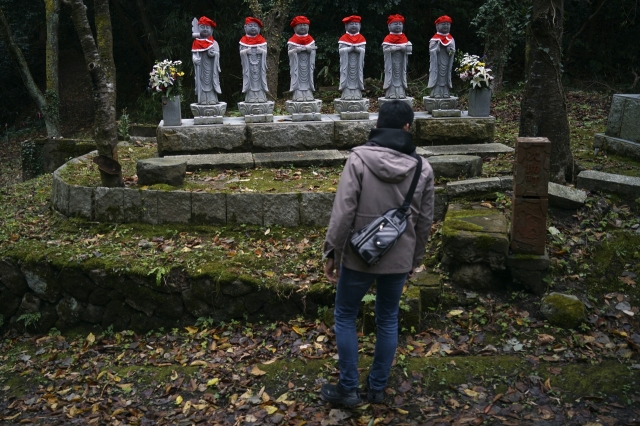 A staff walks through a tunnel at Sado Kinzan Gold Mine historic site in Sado, Niigata prefecture, Japan, Sunday. (AP)