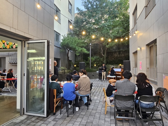 Artists and their families have a gathering on Oct. 26 at Malli-dong Public Housing. (Park Yuna/The Korea Herald)