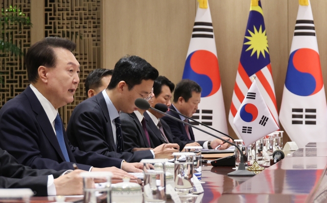 President Yoon Suk Yeol (left) speaks during bilateral talks with Malaysia's Prime Minister Anwar Ibrahim (not pictured) at the presidential office in Seoul on Monday. (Yonhap)