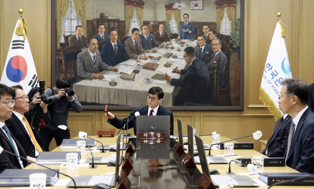 Bank of Korea Gov. Rhee Chang-yong bangs a gavel during a monetary policy board meeting held at the central bank's headquarters in Seoul, Thursday. (Joint Press Corps-Yonhap)