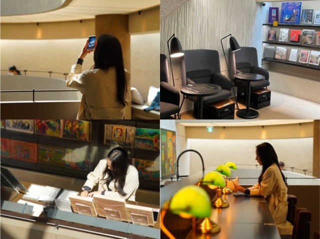 A woman captures the interior views and enjoys reading and browsing books at Graphic Comic Book Cafe in Itaewon, Yongsan-gu. (TripCody)