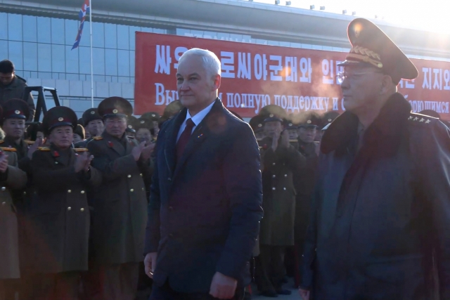 In this photo taken from a video released by the Russian Defense Ministry press service, Russian Defense Minister Andrei Belousov, left, is welcomed by North Korean Defense Minister No Kwang-chol upon his arrival at Pyongyang International Airport outside of Pyongyang, North Korea Friday. (Russian Defense Ministry Press Service via AP)