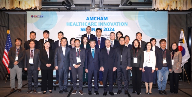 AmCham Chairman and CEO James Kim (front row, sixth from left) poses for a photo with other industry leaders at the AmCham Healthcare Innovation Seminar 2024 at the Four Seasons Hotel in Seoul on Dec. 3, 2024. (AmCham)