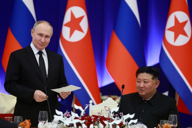 Russia's President Vladimir Putin and North Korea's leader Kim Jong-un attend a state reception in Pyongyang, North Korea June 19, 2024. (Pool via Reuters)