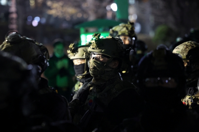 Military forces stand outside the National Assembly in Yeouido, Seoul, after President Yoon Suk Yeol declared martial law, in Seoul, Tuesday. (Reuters-Yonhap)