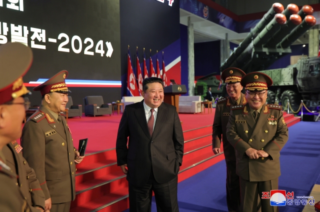 The National Defence Development-2024 opens in Pyongyang on Nov. 21, 2024, with North Korean leader Kim Jong-un (center) in attendance, in this photo provided by the North's official Korean Central News Agency the following day. (Yonhap)