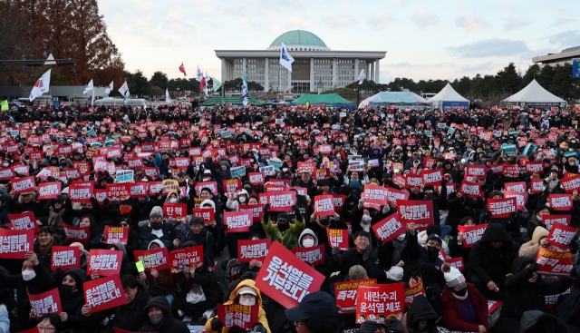 A mass rally is held in front of the National Assembly building in western Seoul on Sunday, as the National Assembly is set to vote on an impeachment motion against President Yoon Suk Yeol. (Yonhap)