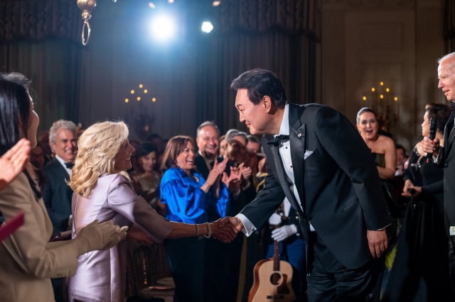 President Joe Biden and First Lady Jill Biden, President Yoon Suk Yeol of the Republic of Korea and Mrs. Kim Keon Hee enjoy a performance by Broadway stars Norm Lewis, Lea Salonga and Jessica Vosk following the State Dinner, on April 26, 2023, in the State Dining Room of the White House. President Yoon shakes hands with Dr. Biden after his surprise rendition of Don McLean’s “American Pie”. (White House)