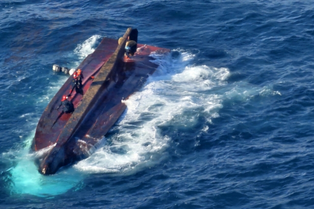 A fishing boat is seen capsized after colliding with a cargo ship at the southeastern coast near Gyeongju, North Gyeongsang Province, Monday. (Pohang Coast Guard)