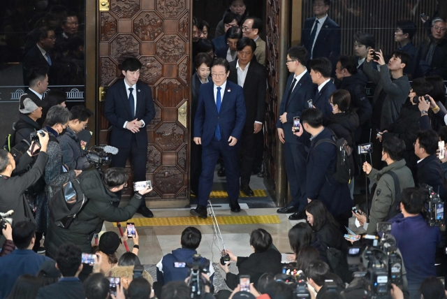 South Korea's main opposition Democratic Party leader Lee Jae-myung (center) walks out from the main conference hall of the National Assembly in Seoul on December 4, after South Korea President Yoon Suk Yeol declared martial law. Yoon on December 3 declared martial law, accusing the opposition of being 