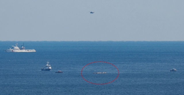 The Coast Guard prepares to conduct a rescue and towing operation for a fishing boat that capsized after colliding with a cargo ship in waters near Gyeongju, about 270 kilometers southeast of Seoul, on Dec. 9, Monday. (Yonhap)