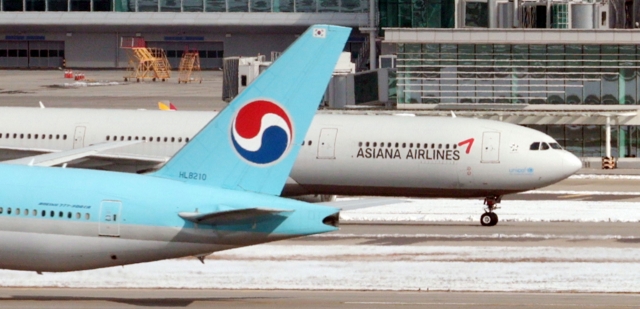 Planes of Korean Air Co. and Asiana Airlines Inc. are seen on the tarmac at Incheon International Airport, west of Seoul, in this Nov. 29 file photo. (Yonhap)