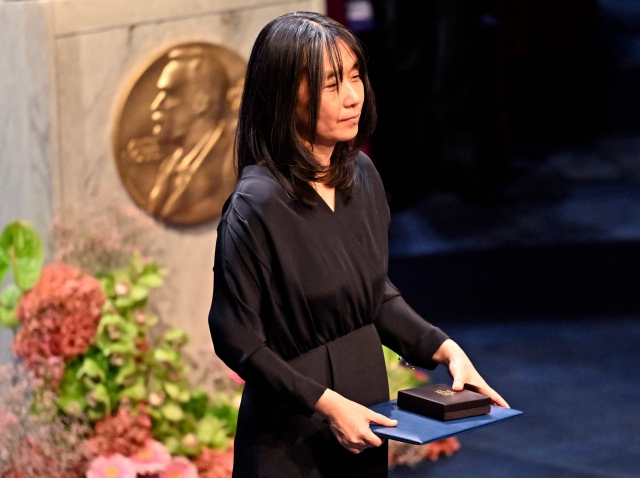 Nobel Prize in literature laureate and South Korean writer Han Kang poses with her award during the Nobel Prize award ceremony at the Concert Hall in Stockholm, Tuesday. (AFP-Yonhap)