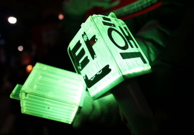 Citizens gathered near the National Assembly Station in Yeongdeungpo-gu, Seoul, to participate in a candlelight vigil calling for the impeachment of the president, Friday. Attendees were seen holding boy group NCT's light sticks, with the word “Impeachment” written on them. (Yonhap)