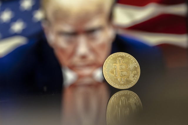 An illustration shows a Bitcoin mockup in front of an image of US President-elect Donald Trump (EPA-Yonhap)