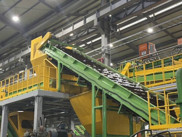 Compressed plastic waste is put into a machine to be washed and boiled in hot water to remove any impurities before being shredded at Yuil Industries, located in Gangseo-gu, Busan. (Lee Jung-joo/The Korea Herald)