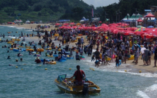 Vacationers swim, sunbathe at provincial beach