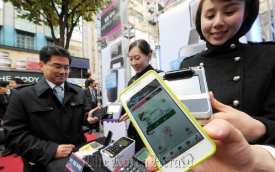 In Myeong-dong, mobile phones replace credit cards