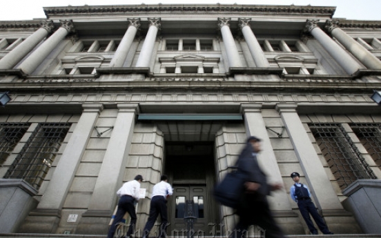 BoJ cuts economic view for second month