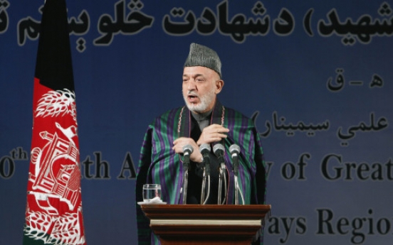 Karzai condemns video of urination on corpses